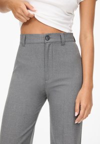 Gray tailored trousers with a button closure, flat front, and side pockets, made of smooth fabric, featuring a straight-leg design and subtle texture.