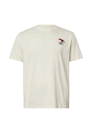 T-shirt en coton couleur crème avec un col ras du cou, arborant un petit motif brodé d'un personnage sur un skateboard en rouge et noir.