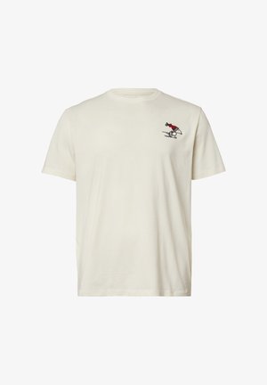 T-shirt en coton couleur crème avec un col ras du cou, arborant un petit motif brodé d'un personnage sur un skateboard en rouge et noir.