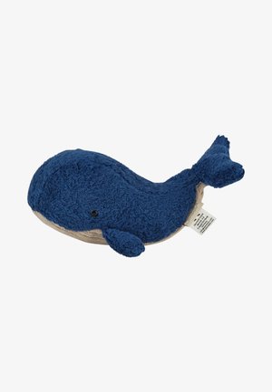 Soft, dark blue plush whale toy with small black eyes and beige underside, lying flat with fabric tag visible on its side.