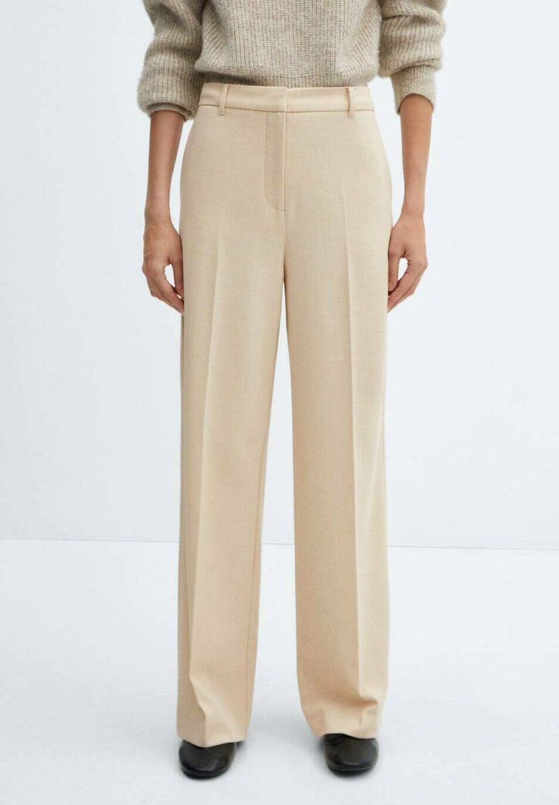 Lange beige broek gemaakt van lichtgewicht stof, met voorplooien en een op maat gemaakte tailleband voor een gestructureerde pasvorm.