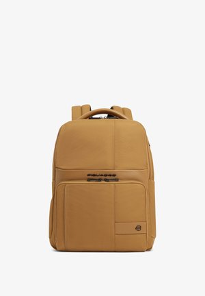 Tan-colored rectangular backpack with front zipper pocket, top handle, padded shoulder straps, and Piquadro logo on front panel.