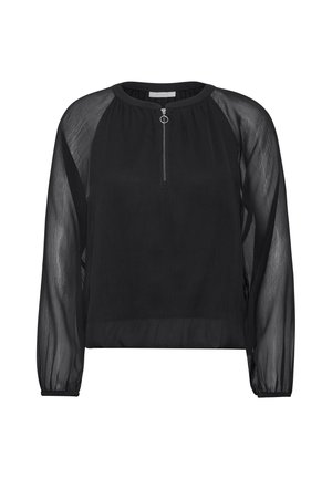 Blusa negra transparente con cuello redondo, mangas largas y cremallera frontal con un tirador circular. Tela suave con ligera textura.