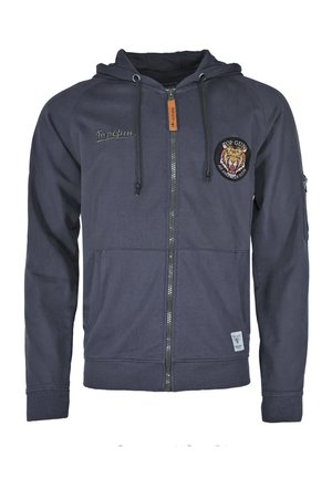 Granatowa bluza zip-up wykonana z miękkiego materiału, z kapturem na sznurki, przednimi kieszeniami i haftowaną łatą z tygrysem na lewej piersi.