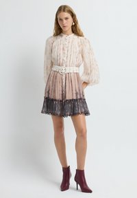 Abito a maniche corte, con bottoni, caratterizzato da un design degradé in morbido beige e grigio scuro, con un orlo rifinito in pizzo e una cintura bianca larga.