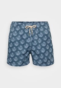 Dunkelblaue Badehose mit einem wiederholenden weißen Muster von Comicfiguren, elastischem Bund und Kordelzug. 
