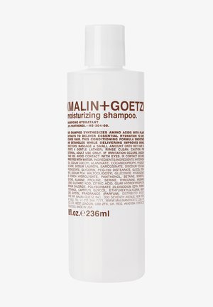 White plastic bottle of moisturizing shampoo, featuring brown text. 236 ml capacity. Label lists ingredients and usage instructions.