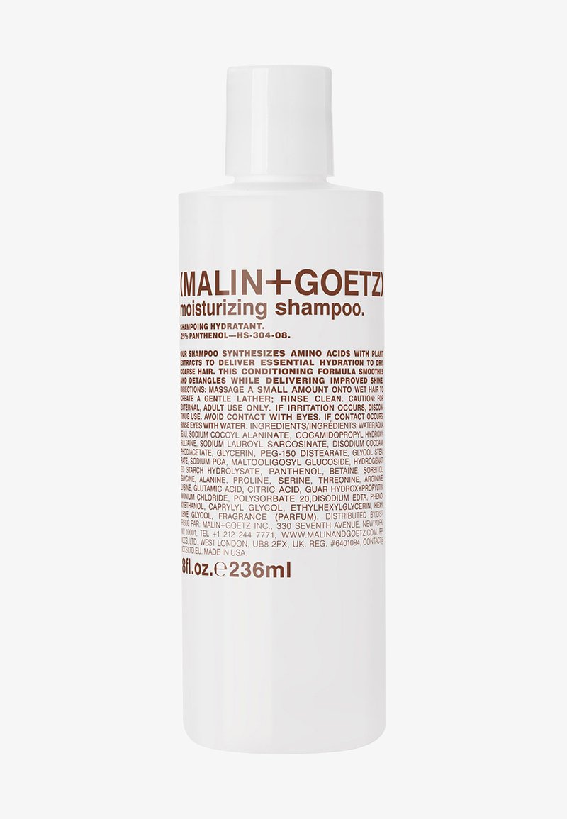 Weiße Plastikflasche mit feuchtigkeitsspendendem Shampoo, mit braunem Text. 236 ml Kapazität. Das Etikett listet Inhaltsstoffe und Anwendungshinweise auf.