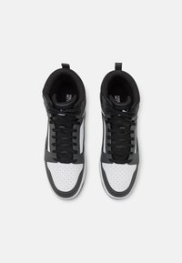 High-top sneakers with black and white leather, featuring perforated toe box, black laces, and grey accents on the sides and heel.