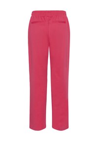 Pantalon de jogging rose avec taille élastique, deux poches arrière, coupe droite et texture douce, idéal pour les tenues décontractées ou les moments de détente.