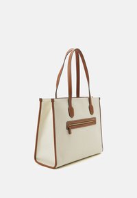 Tote bag in cream canvas with brown leather accents. Features dual handles and a front zippered pocket with gold hardware.