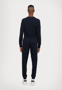 EA7 Emporio Armani PANTALONI - Träningsbyxor - blue