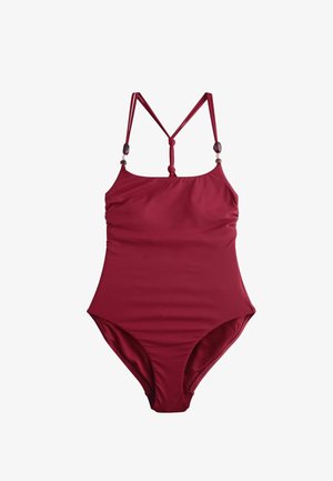 Tamsiai raudonas vientisas maudymosi kostiumėlis su reguliuojamomis plonomis petnešėlėmis, puoštomis dekoratyvinėmis karoliukais, ir centrine nugaros raišteliu.