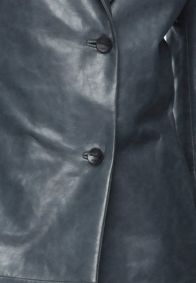Dark green leather jacket featuring a smooth texture, single-breasted design, and two black buttons at the front.