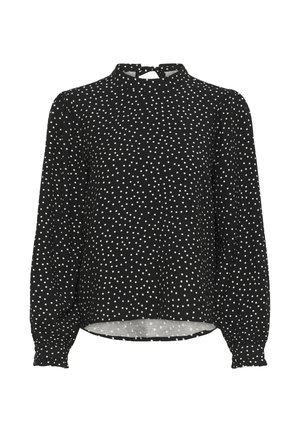 Blouse noire à manches longues avec des pois blancs, col montant et manches bouffantes froncées. Le tissu a une texture lisse ; présente une fermeture en forme de goutte au dos.