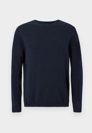 Maglione lavorato a maglia blu navy con maniche lunghe, scollatura a girocollo e polsini e orlo a coste. Presenta un piccolo logo sul petto.