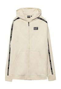 Felpa con zip beige chiaro, dotata di tasca frontale, strisce laterali nere e un patch del logo EA7 sul lato sinistro del petto. Tessuto morbido.