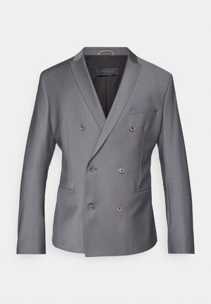 Grå dobbeltspent blazer laget av teksturert stoff, med spiss krage, to frontlommer og seks knapper foran.