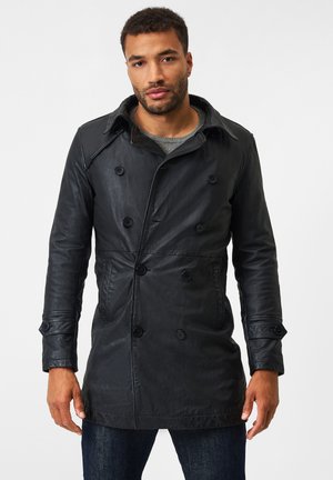 Black leather double-breasted coat with a notched collar, belted cuffs, and two front pockets. Smooth texture and tailored fit.