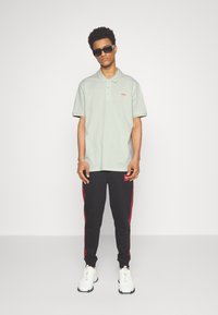 HUGO DONOS - Polo - light pastel green