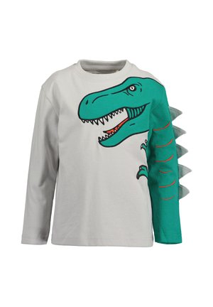 Langærmet hvid børneskjorte med print af et grønt dinosaurhoved og arm, med stofpigge langs højre ærme.