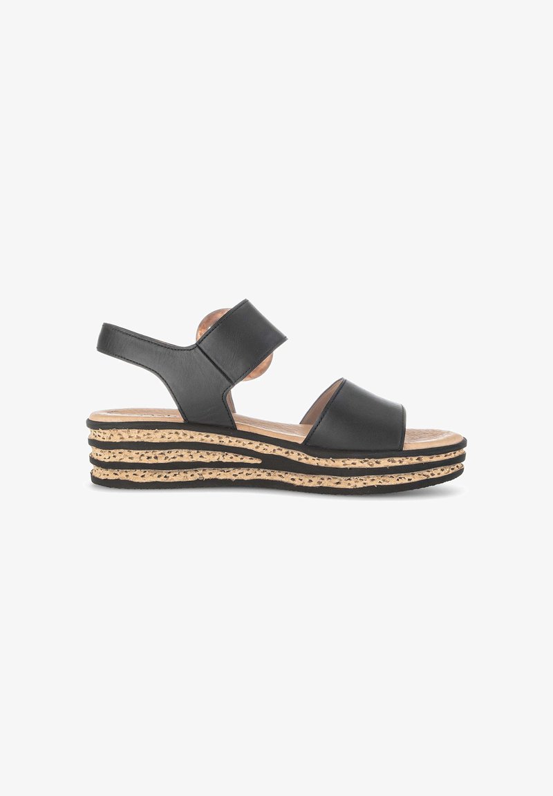 Sandale noire à bout ouvert avec deux larges brides et une semelle plateforme en liège beige avec des accents noirs, vue de côté externe.