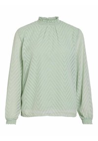 Blouse vert clair à manches longues avec texture chevron, col montant à volants et poignets élastiques aux manches.