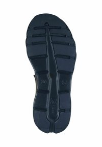 Semelle en caoutchouc noir avec des rainures profondes pour une traction optimale. Présente des motifs en relief et des détails de marque. Conçue pour la durabilité et le confort.