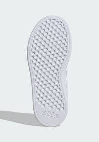 Semelle en caoutchouc blanche avec un motif en nid d'abeille texturé et un logo adidas embossé. Des bords arrondis et des courbes lisses définissent le design.