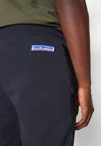 Marine joggers van textiel, elastische tailleband en een blauw-rode Napapijri-logo patch op de achterkant, met een slim fit ontwerp.