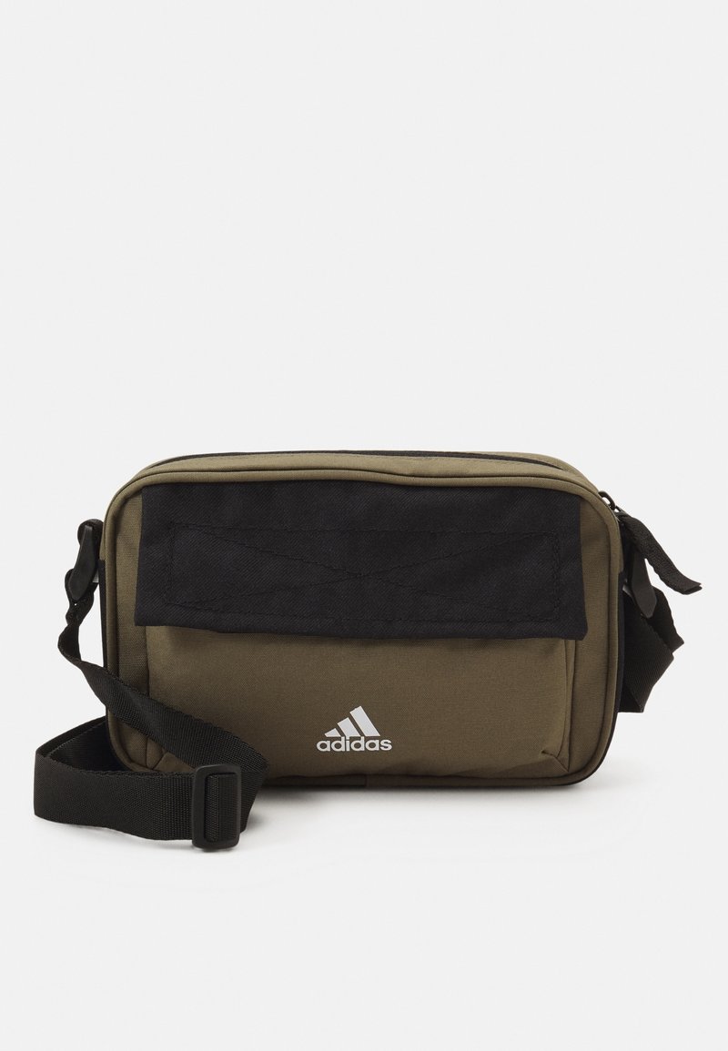 Olive green polyester crossbody bag with black fabric flap and adjustable strap; features white Adidas logo on the front.