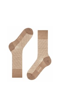 Beige Socken mit einem strukturierten Wabenmuster, glatten Zehen und Fersenakzenten, die ein Markenlabel zeigen und eine Kombination von Materialien präsentieren.