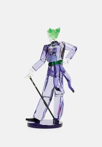 Clear acrylic figurine of a character, featuring transparent purple body, green hair, green belt, and black cane, standing on a circular base.