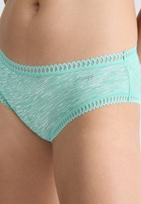 Light turquoise cotton underwear with a textured pattern, featuring decorative lace trim along the waistband and subtle branding.