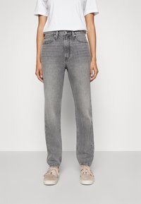 Gray denim high-waisted jeans with a straight leg, featuring classic five-pocket design and subtle fading, paired with beige sneakers.