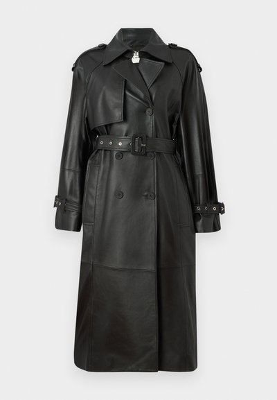 Black leather trench coat with a belted waist, double-breasted buttons, sharp collar, and perforated detailing on sleeves.