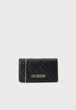 Schwarze gesteppte Lederhandtasche Love Moschino mit silberner Kette und Logoaufnäher auf der Vorderseite vor einfarbigem Hintergrund.