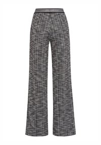 Wide-leg pants made of textured black and white woven fabric. Features a smooth waistband with a contrasting accent. No visible hardware.