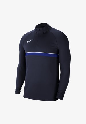 Pull de sport noir à manches longues avec fermeture éclair quart, bande horizontale bleue et blanche sur la poitrine, et logo Nike blanc sur le côté gauche.