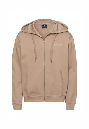 Beżowa bluza z kapturem na zamek, wykonana z miękkiego materiału, z przednią kieszenią, sznurkami do regulacji oraz detalem logo na klatce piersiowej. Widoczny strukturalny materiał wewnętrzny.