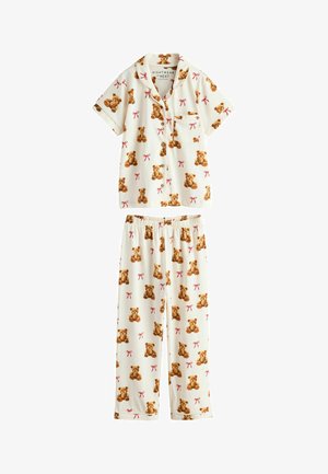 Cream-colored short-sleeve button-up pajama top and pants with brown teddy bear and red bow patterns, featuring a chest pocket on the top.
