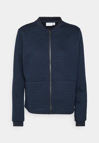 Granatowa pikowana kurtka pilotka z pełnym zamkiem, okrągłym dekoltem, długimi rękawami i ściągaczami przy mankietach. Posiada dwie przednie kieszenie oraz kontrastowe przeszycia.