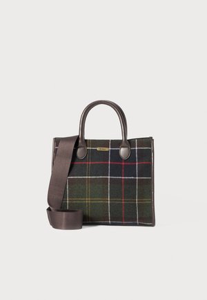 Tote bag in dark plaid pattern with green, red, and white lines. Made of fabric with brown leather handles and a detachable shoulder strap.