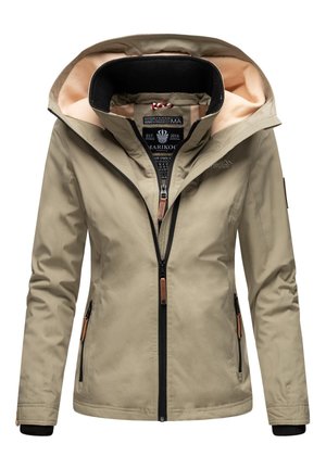 Veste softshell beige pour femmes avec capuche, doublure en polaire pêche, fermetures éclair double et poches latérales zippées, conçue pour une utilisation en extérieur.
