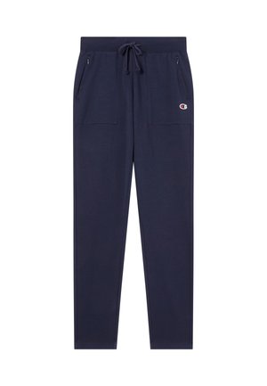 Pantalon de survêtement bleu marine en tissu doux, avec taille à cordon, deux poches zippées et logo sur la cuisse gauche.