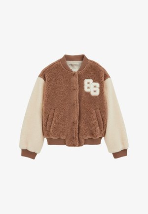 Barna és krémszínű bolyhos bomber dzseki bársonyos textúrával, bordázott mandzsettákkal és patentos zárral. Mellrészen hímzett "86" szám díszíti.