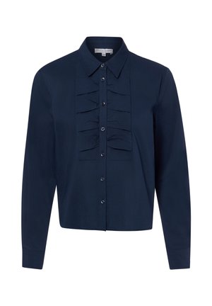 Blouse bleu marine à manches longues avec boutonnière devant et détails de volants plissés sur la poitrine, col pointu et poignets ajustés.