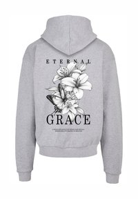 Gray hooded sweatshirt featuring a floral design, butterfly, and text. The artwork is printed in black on the back. Soft fabric with ribbed cuffs.