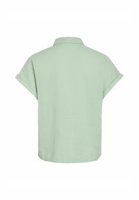 Camicia a maniche corte, tessuto verde chiaro, colletto e polsini arrotolati, vestibilità comoda, superficie testurizzata, orlo dritto, design semplice.