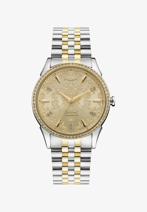 Gold and silver-tone watch with a patterned dial, crystal accents, and a two-toned bracelet. Features a round case and mineral glass.